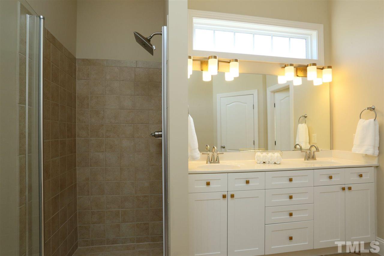 1164 Harp Street Raleigh, NC 27604 - Photo 18 of 25 a bathroom with a double vanity sink mirror and shower