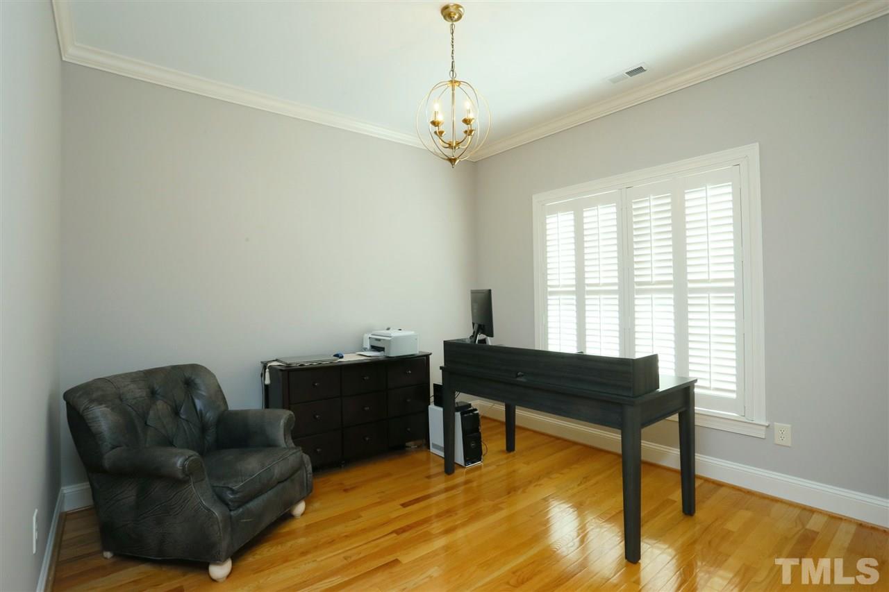 1164 Harp Street Raleigh, NC 27604 - Photo 20 of 25 a living room with furniture and a chandelier