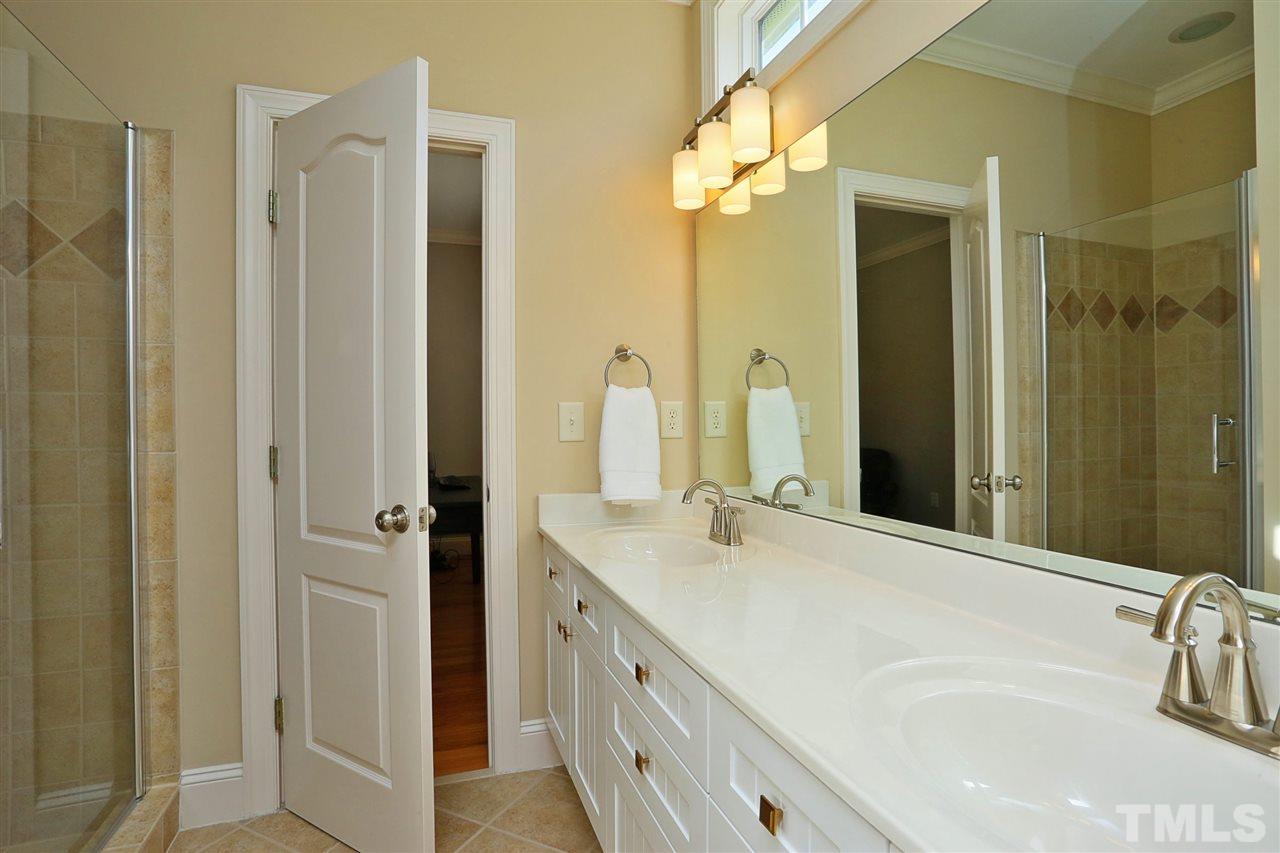 1164 Harp Street Raleigh, NC 27604 - Photo 21 of 25 a bathroom with a granite countertop sink and a mirror