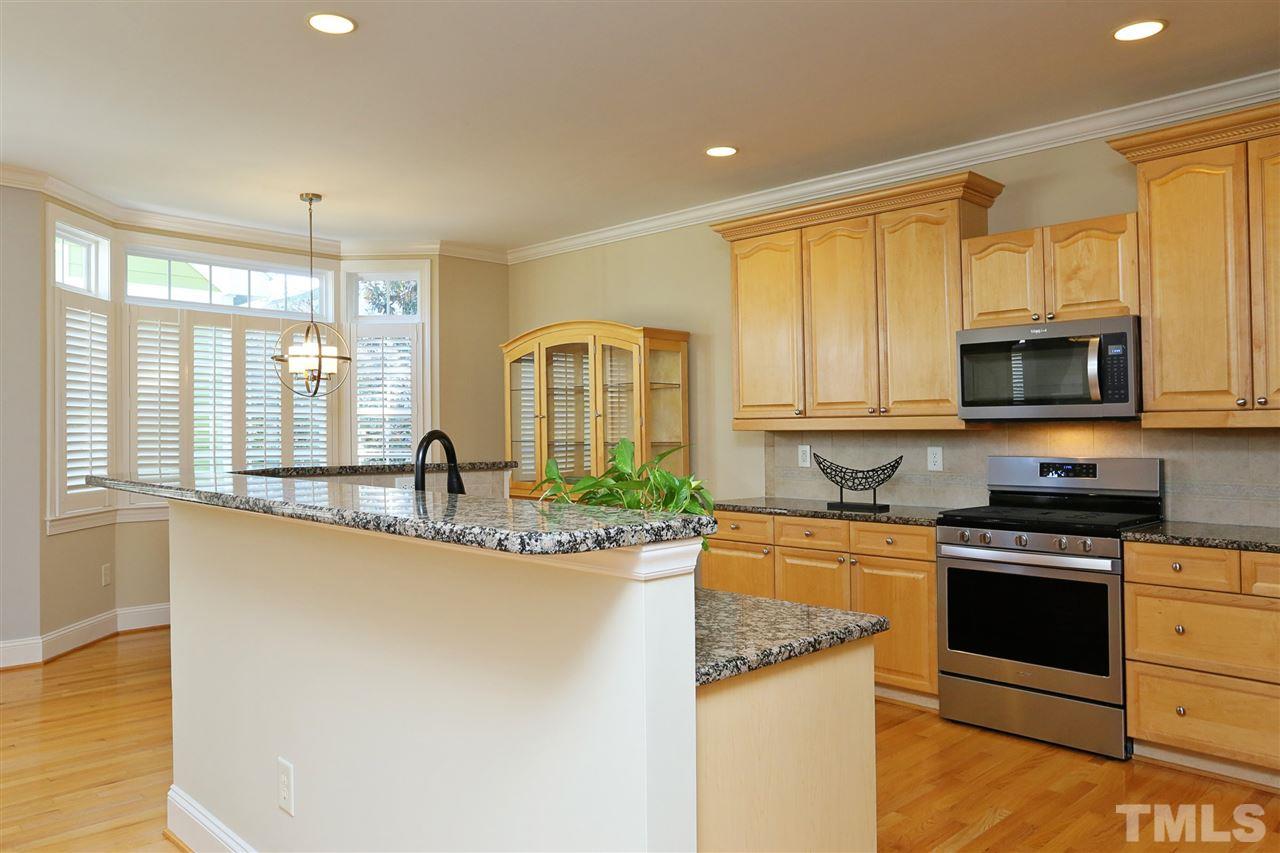 1164 Harp Street Raleigh, NC 27604 - Photo 6 of 25 a kitchen with stainless steel appliances granite countertop a stove a sink and a microwave