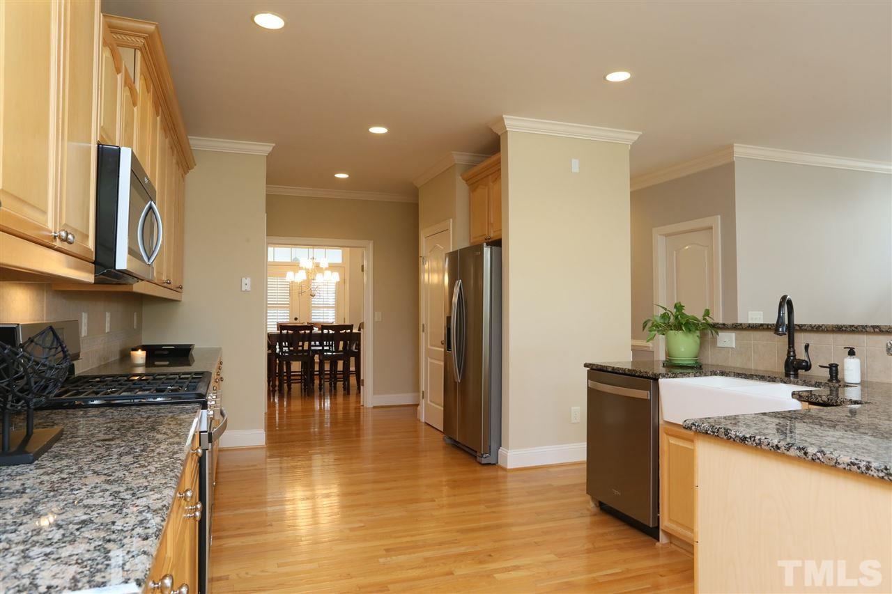 1164 Harp Street Raleigh, NC 27604 - Photo 8 of 25 a kitchen with stainless steel appliances granite countertop a refrigerator a sink a stove and island