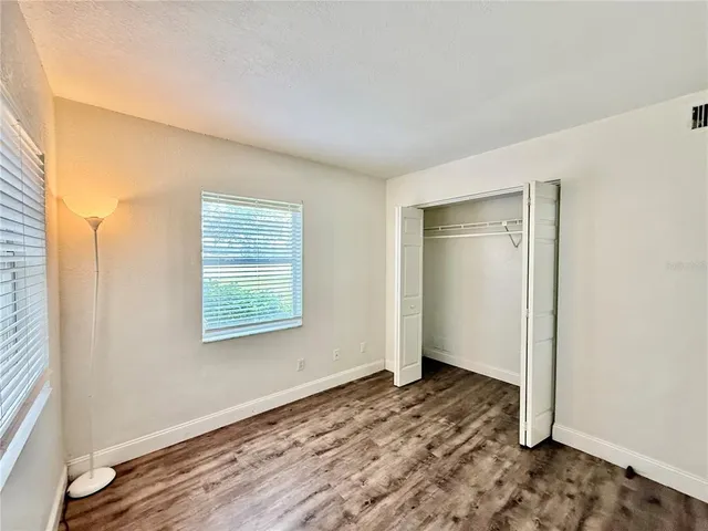 a view of a room with wooden floor and window