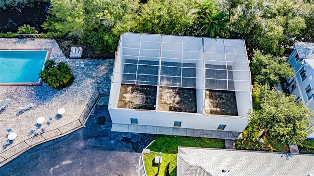 a view of a house with a backyard and potted plants
