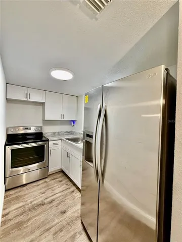 a kitchen with a refrigerator and a sink