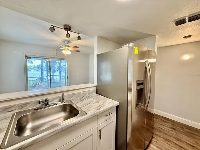 a kitchen with a refrigerator and a sink