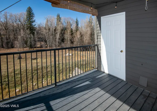 a view of balcony with wooden floor