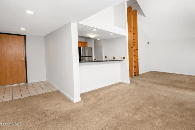 a view of an empty room with a fireplace