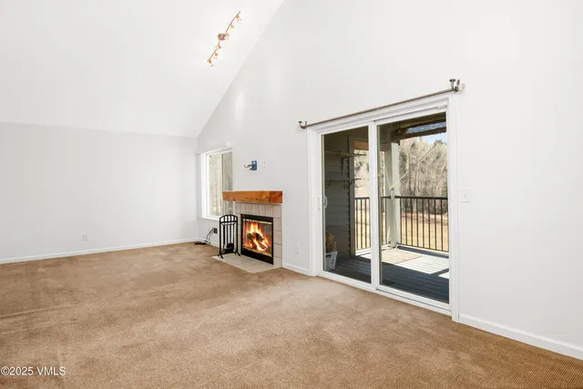 a view of an empty room with a fireplace