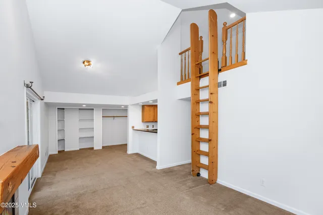 an empty room with a kitchen and a sink