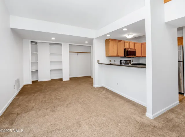 a view of a room with a wooden floor and a window