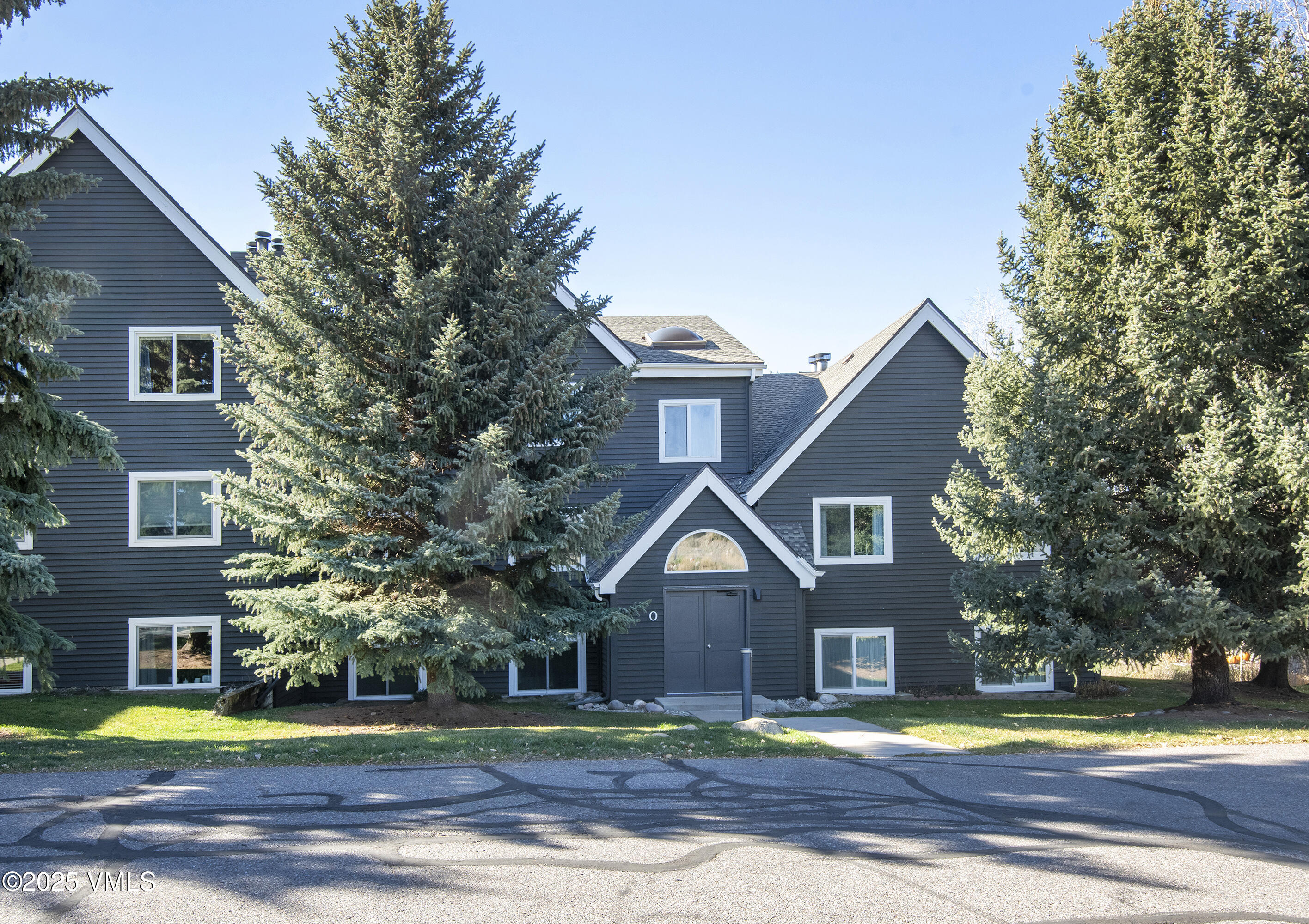 34999 Highway 6, Unit O303 Edwards, CO 81632 - Photo 29 of 35 a front view of a residential houses with yard and trees