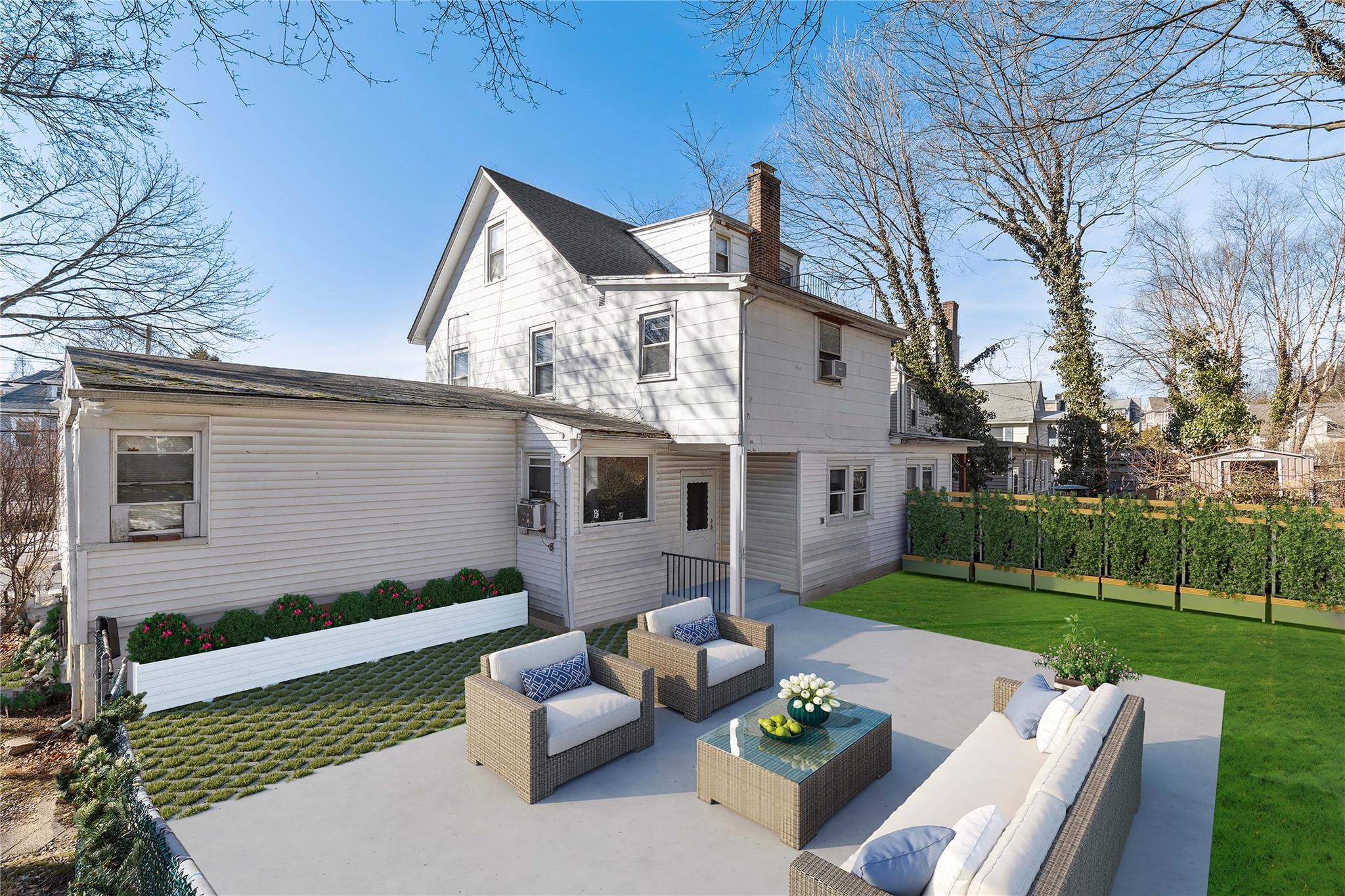 236-238 Purchase Street Rye, NY 10580 - Photo 5 of 15 Virtual Staging of back of house featuring outdoor living space, a lawn, and a patio area