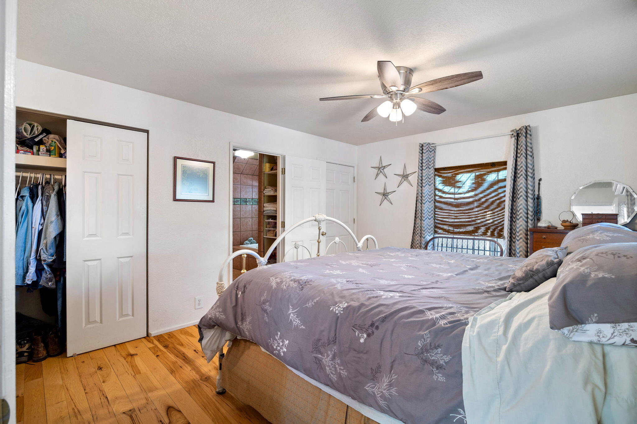 624 Baker Ranch Road Young, AZ 85554 - Photo 14 of 116 a bedroom with a bed and a chandelier