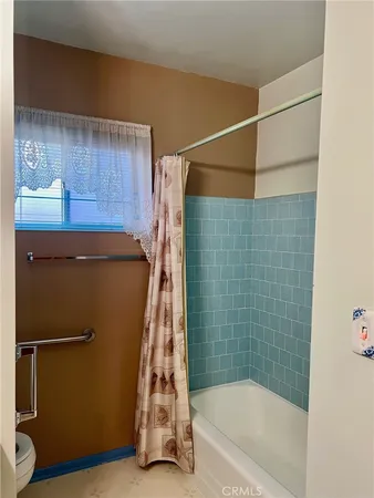 a bathroom with a shower and a sink