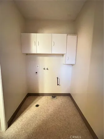 a view of wooden floor and chandelier in a room