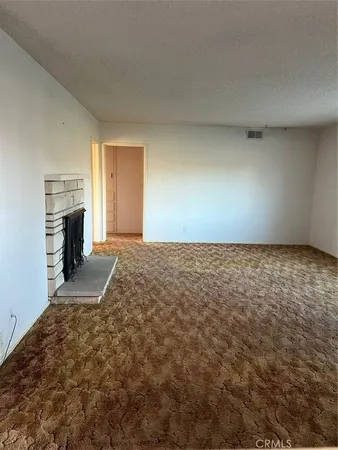 a view of empty room with a fireplace