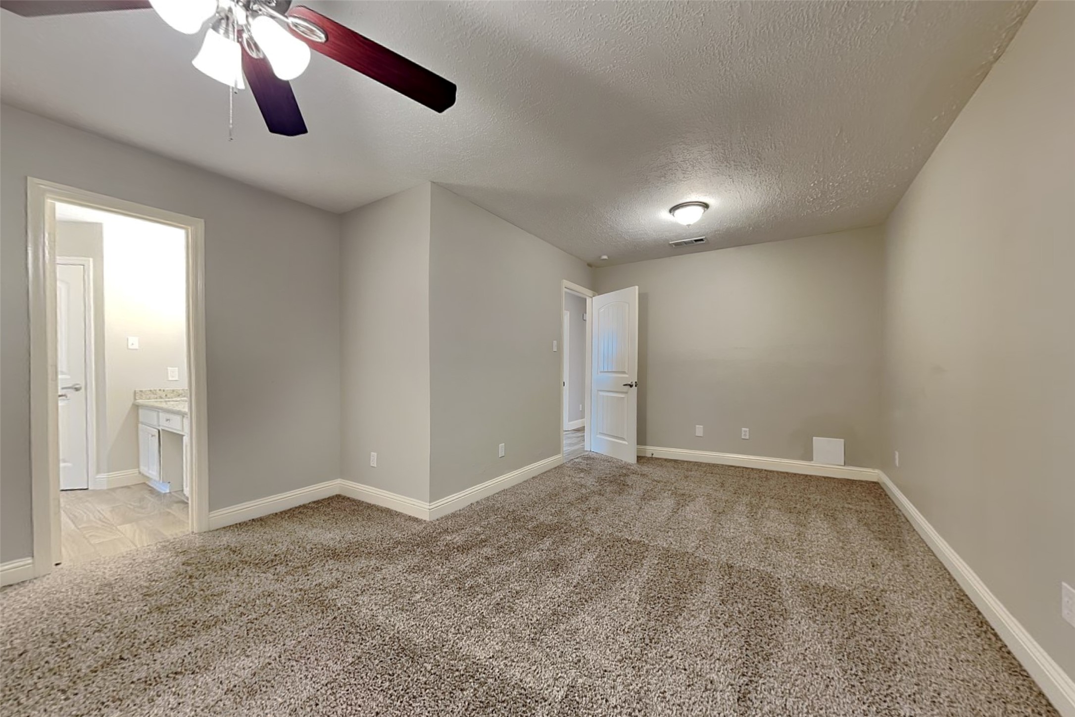 19902 Pinefield Court Humble, TX 77338 - Photo 12 of 23 an empty room with chandelier fan and windows