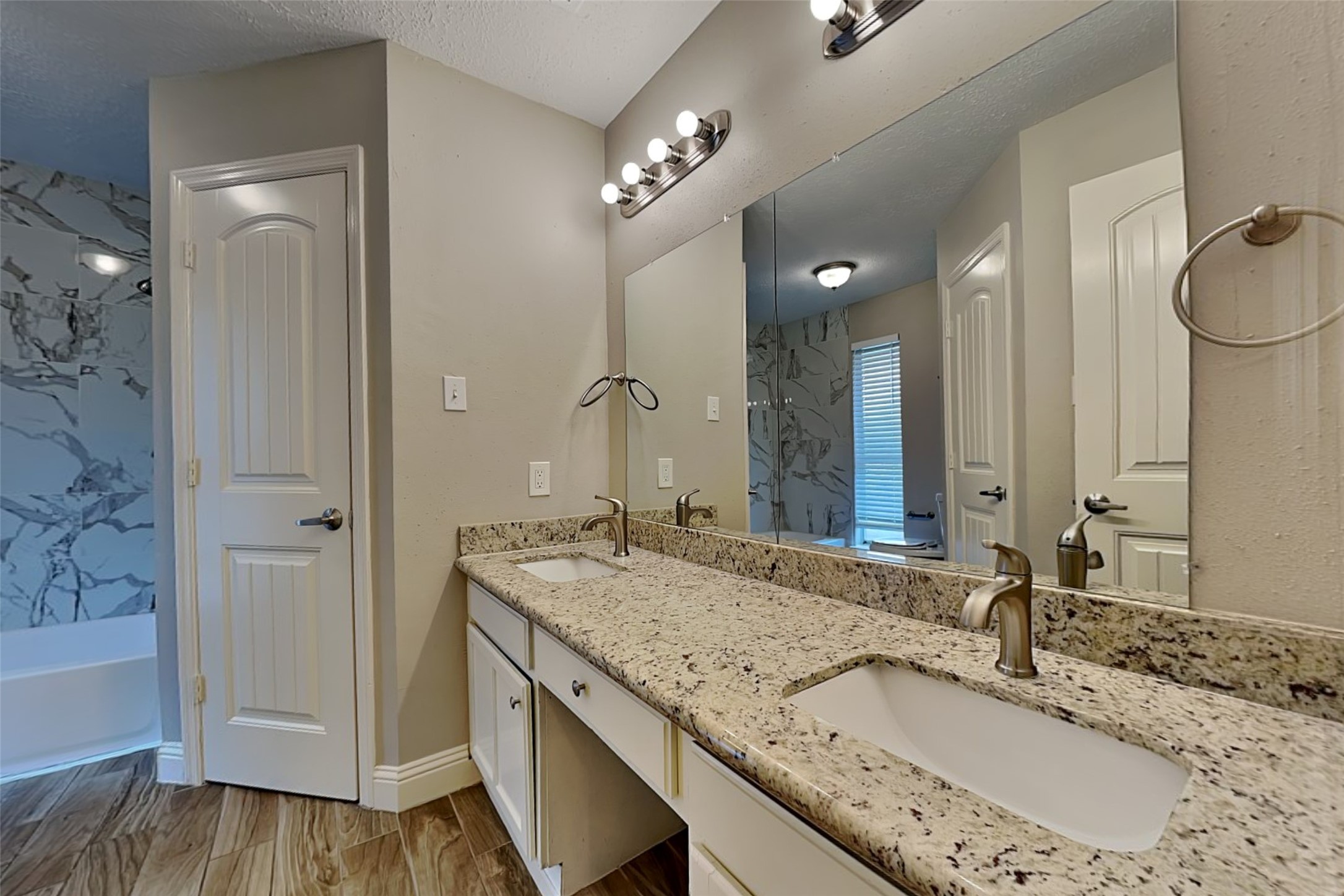 19902 Pinefield Court Humble, TX 77338 - Photo 14 of 23 a bathroom with a granite countertop sink and a mirror