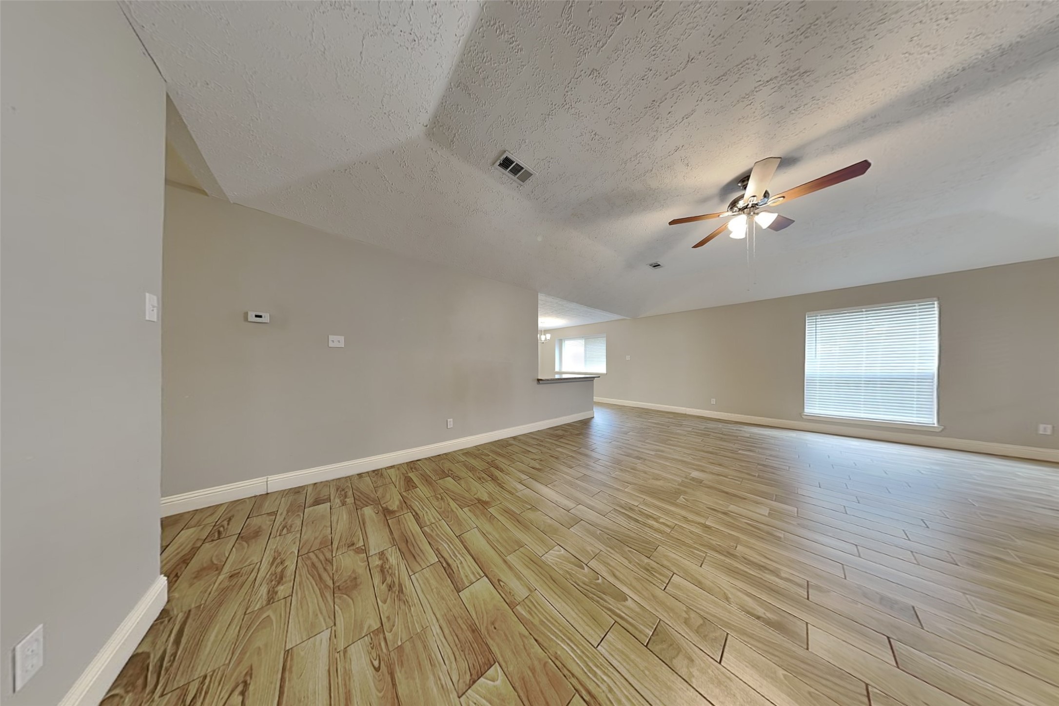 19902 Pinefield Court Humble, TX 77338 - Photo 2 of 23 wooden floor in an empty room with a window
