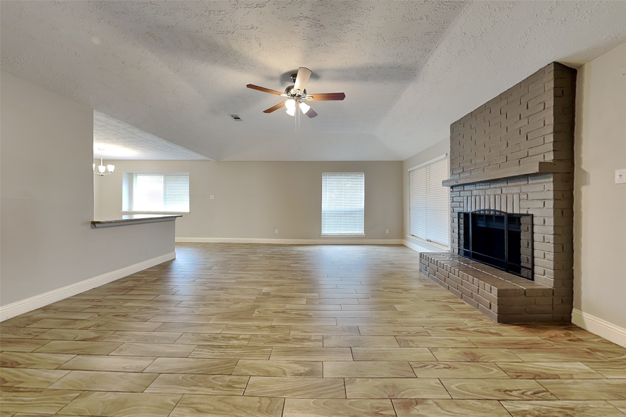 19902 Pinefield Court Humble, TX 77338 - Photo 4 of 23 a view of empty room with fireplace and fan