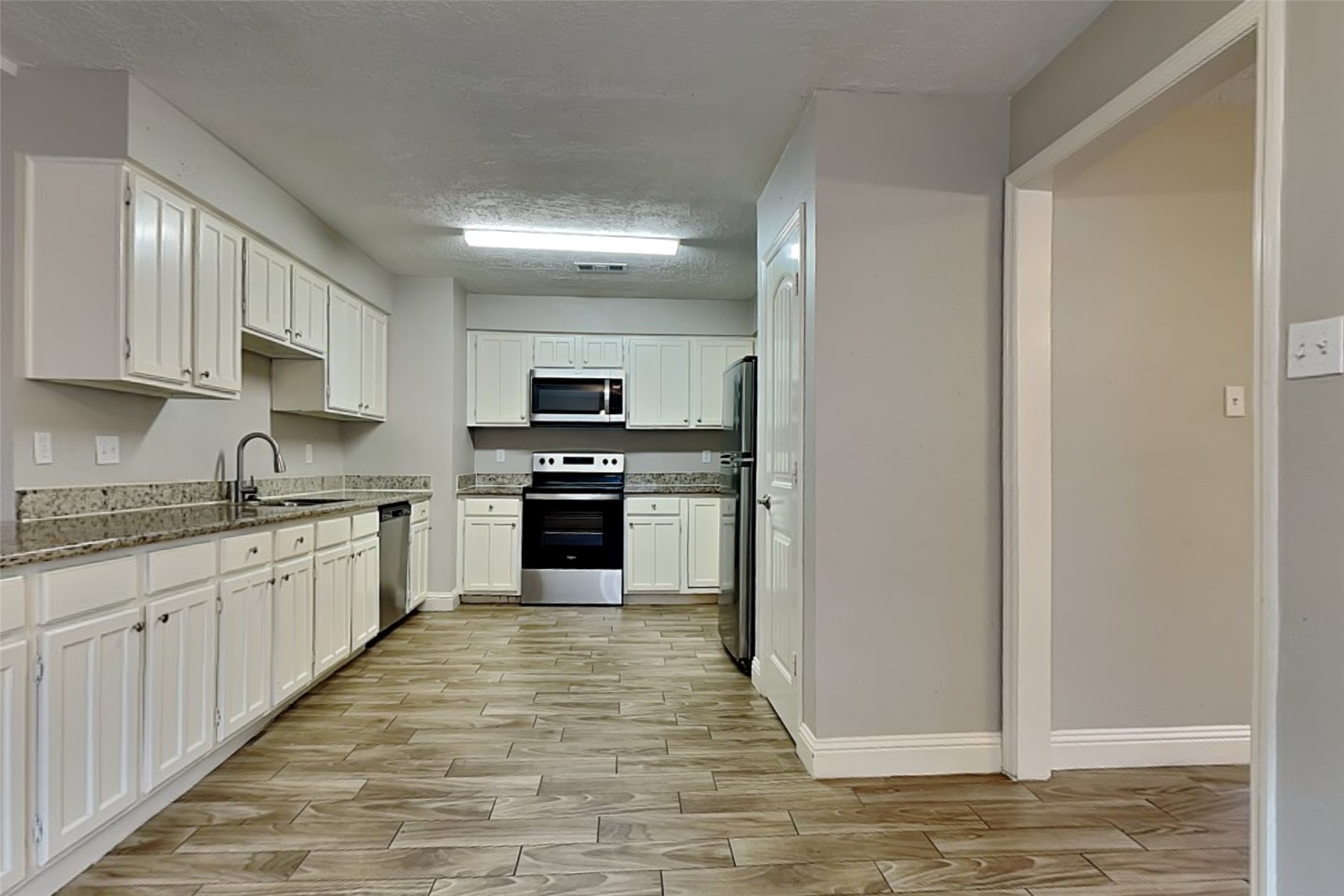 19902 Pinefield Court Humble, TX 77338 - Photo 7 of 23 a large kitchen with cabinets