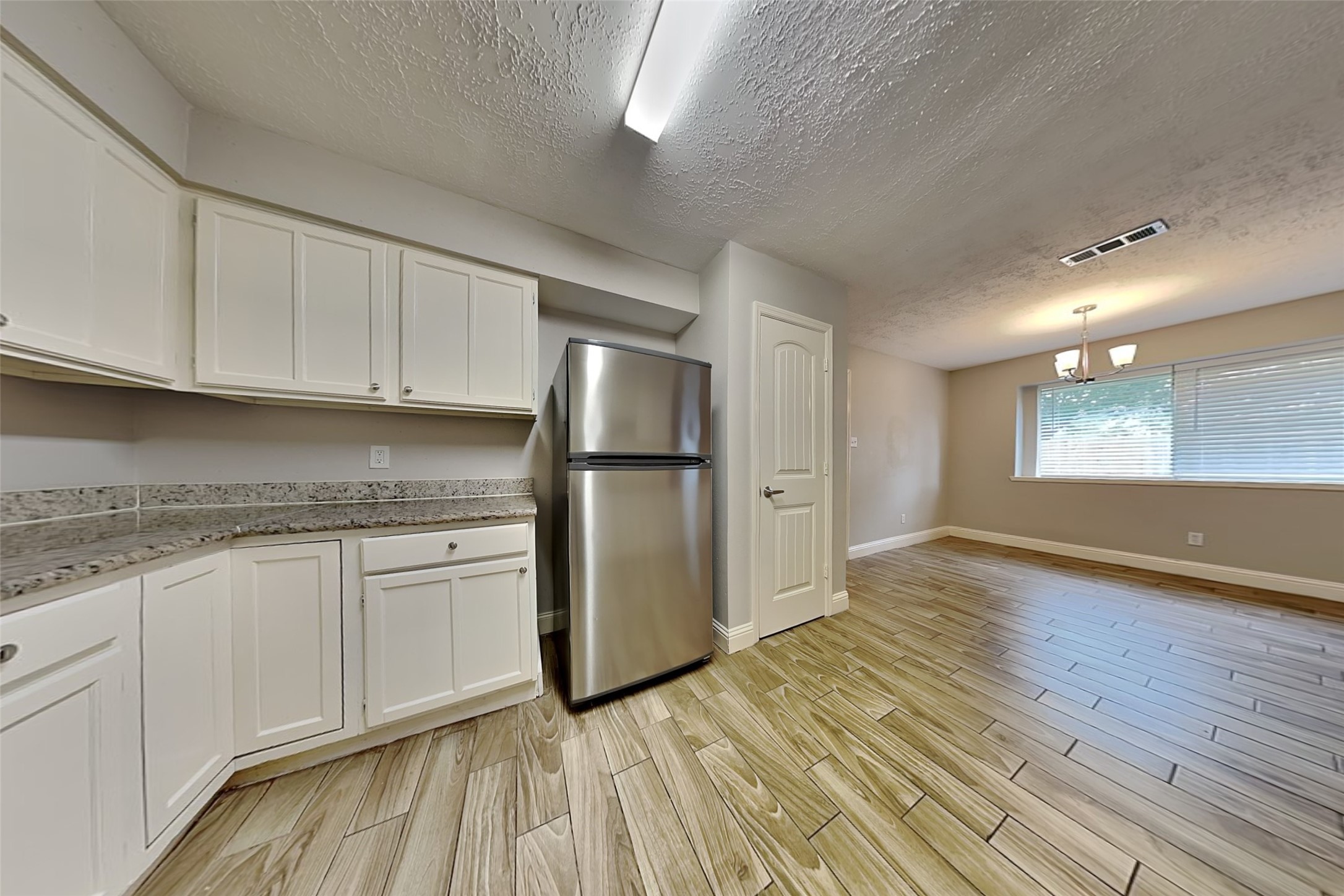19902 Pinefield Court Humble, TX 77338 - Photo 8 of 23 a kitchen with granite countertop a refrigerator sink and cabinets