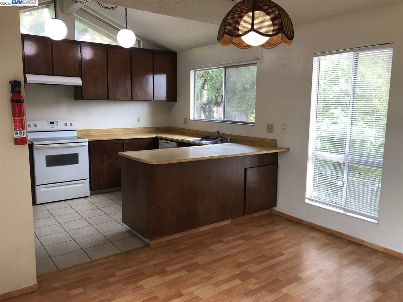 25717 Spring Drive Hayward, CA 94542 - Photo 11 of 13 a kitchen with stainless steel appliances granite countertop a sink stove and cabinets