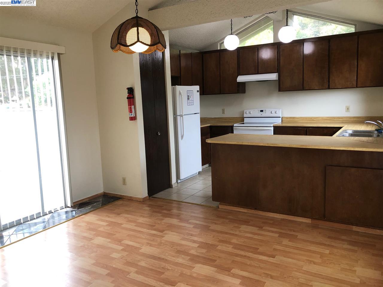 25717 Spring Drive Hayward, CA 94542 - Photo 12 of 13 a kitchen with stainless steel appliances granite countertop a refrigerator a sink dishwasher a stove and a microwave oven on dining table