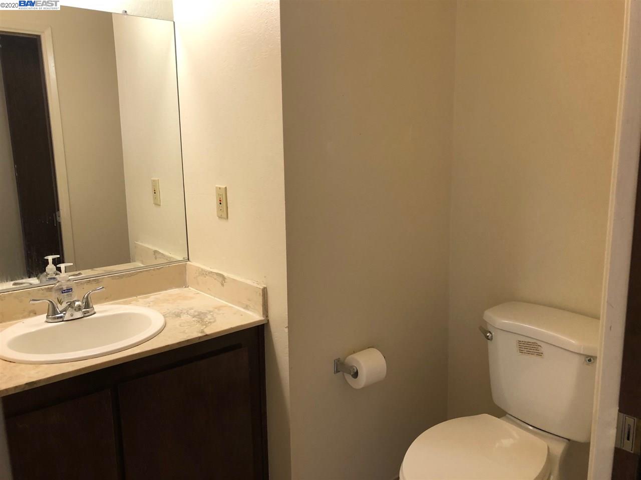 25717 Spring Drive Hayward, CA 94542 - Photo 9 of 13 a bathroom with a granite countertop toilet and a sink