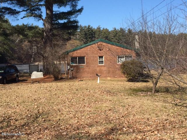 1567 Barber Pond Road Pownal, VT 05261 - Photo 2 of 14 a front view of a house with a yard covered with snow