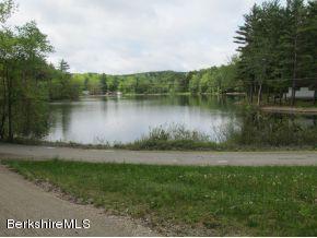 1567 Barber Pond Road Pownal, VT 05261 - Photo 14 of 14 a view of a lake with a yard and large trees
