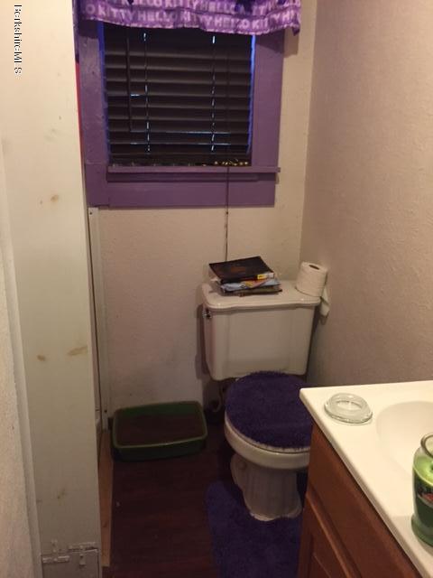 1567 Barber Pond Road Pownal, VT 05261 - Photo 8 of 14 a bathroom with a sink a toilet and a mirror