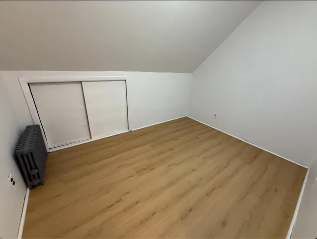 a view of a room with wooden floor