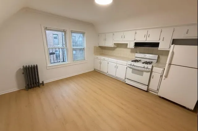 a kitchen with stainless steel appliances granite countertop a stove a refrigerator a sink a microwave and cabinets