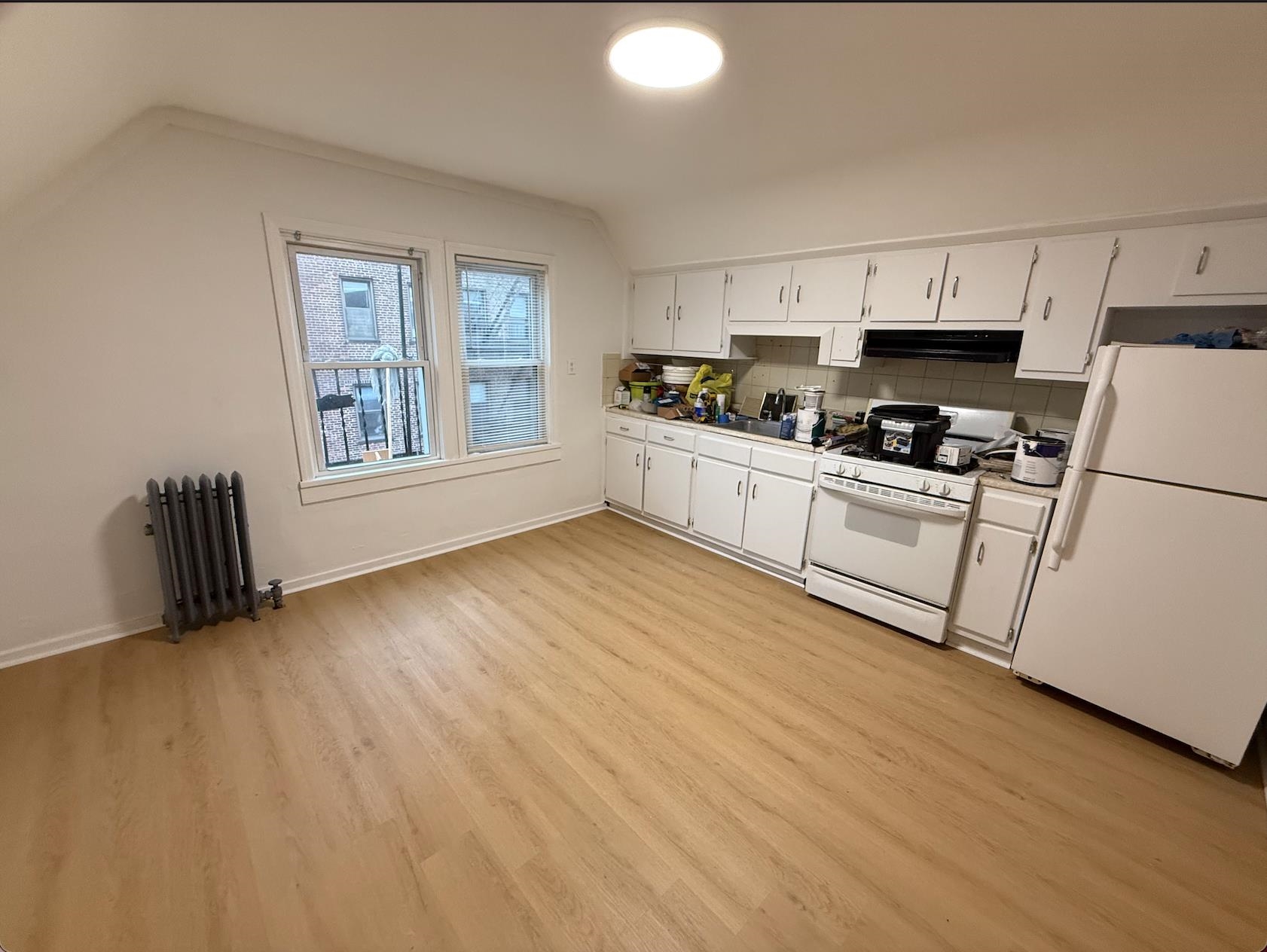 21 49th Street, Unit 3 Weehawken, NJ 07086 - Photo 5 of 5 a kitchen with granite countertop a stove a sink dishwasher and a refrigerator with wooden floor