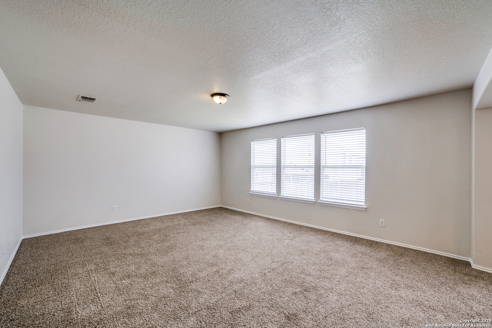 5616 Poppy Seed Run Leon Valley, TX 78238 - Photo 17 of 42 an empty room with a empty space and windows