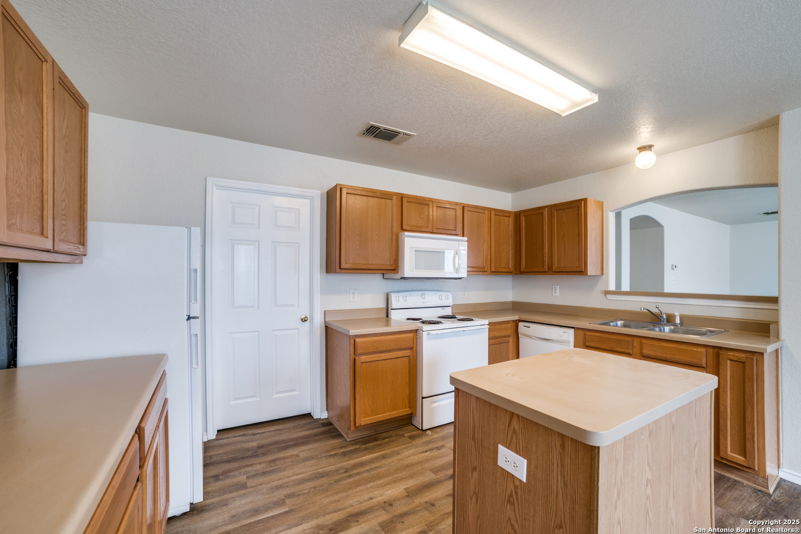 5616 Poppy Seed Run Leon Valley, TX 78238 - Photo 24 of 42 a kitchen with a stove top oven sink and cabinets