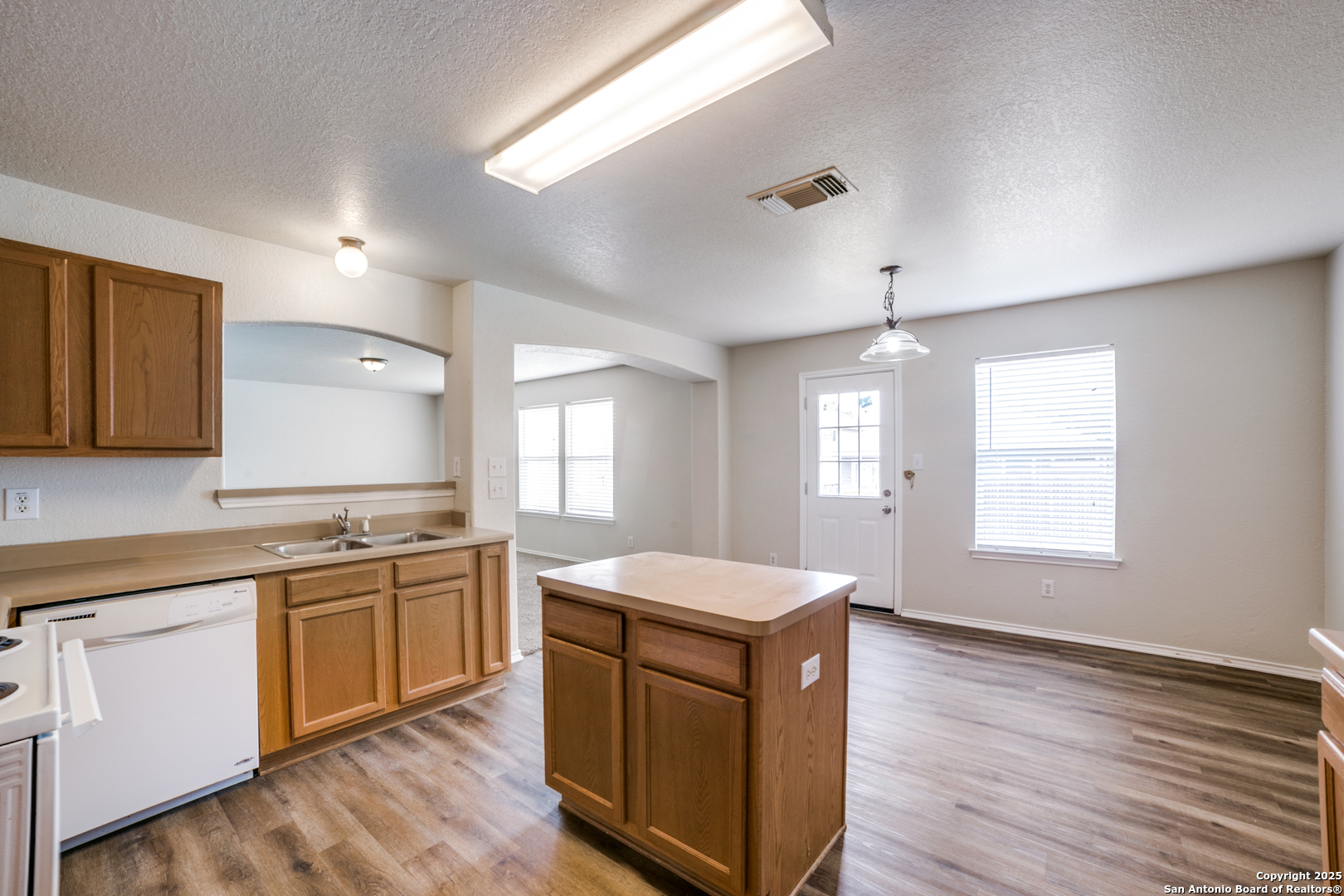 5616 Poppy Seed Run Leon Valley, TX 78238 - Photo 25 of 42 a kitchen with a sink stove and cabinets