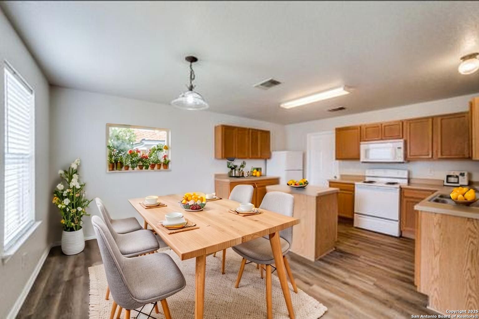 5616 Poppy Seed Run Leon Valley, TX 78238 - Photo 8 of 42 a view of a dining room with furniture window and wooden floor