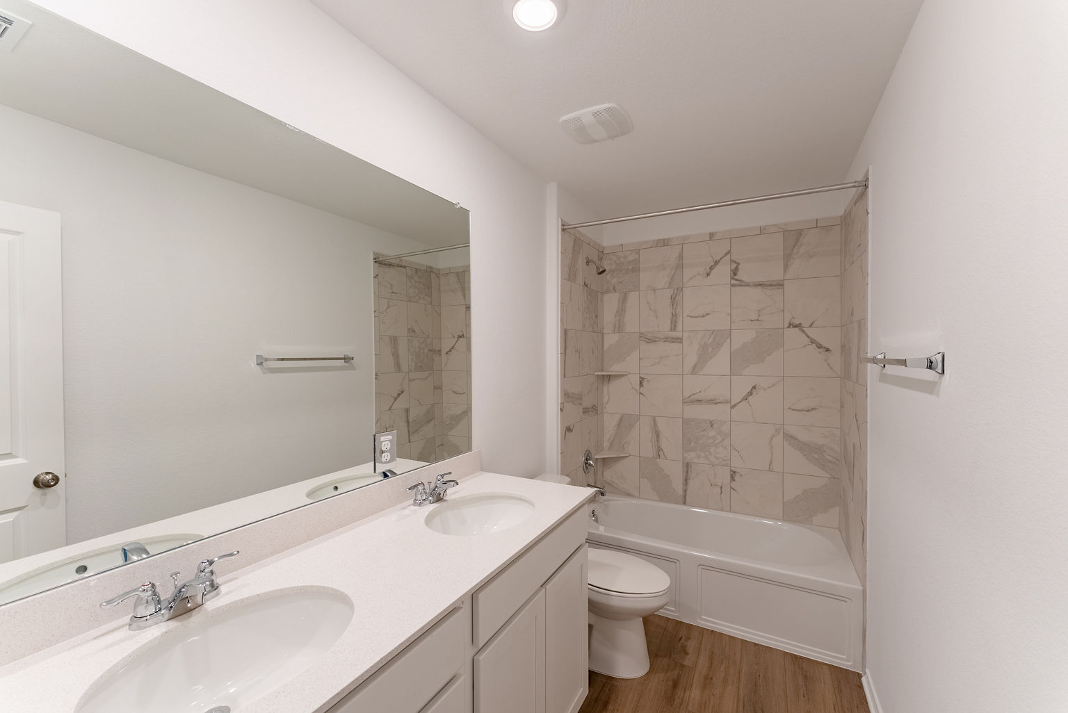137 River Rise Road Kyle, TX 78640 - Photo 21 of 26 Bathroom with shower / washtub combination, double vanity, and light wood-style floors