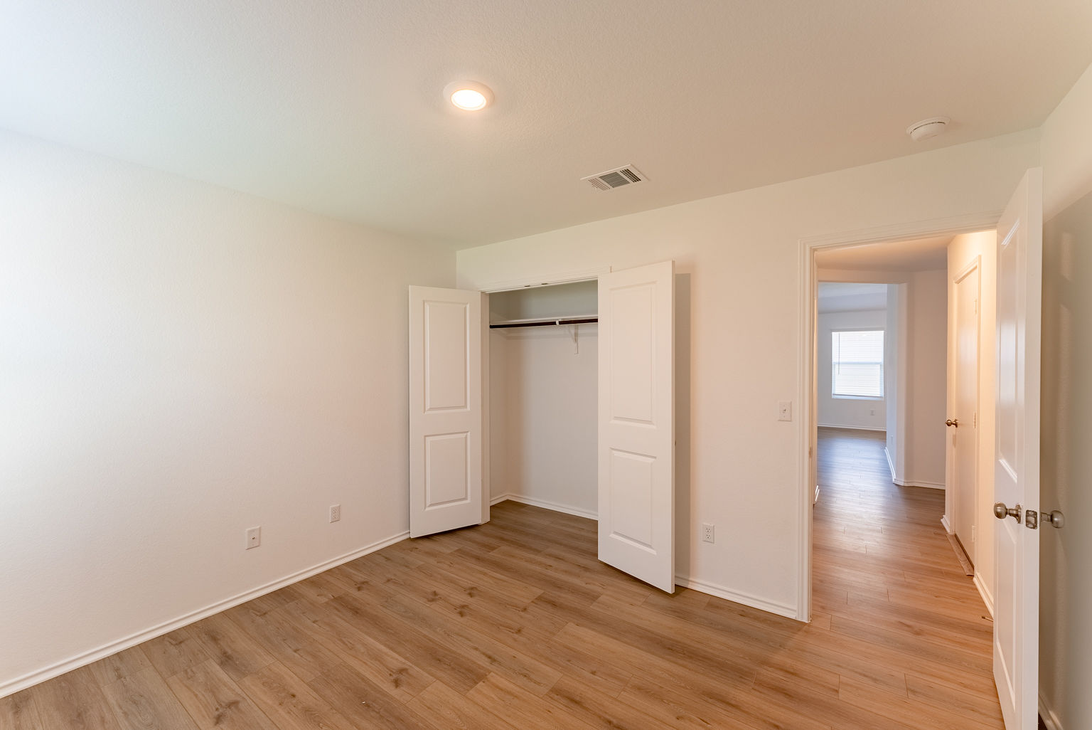 137 River Rise Road Kyle, TX 78640 - Photo 23 of 26 Unfurnished bedroom featuring light wood-style floors and a closet
