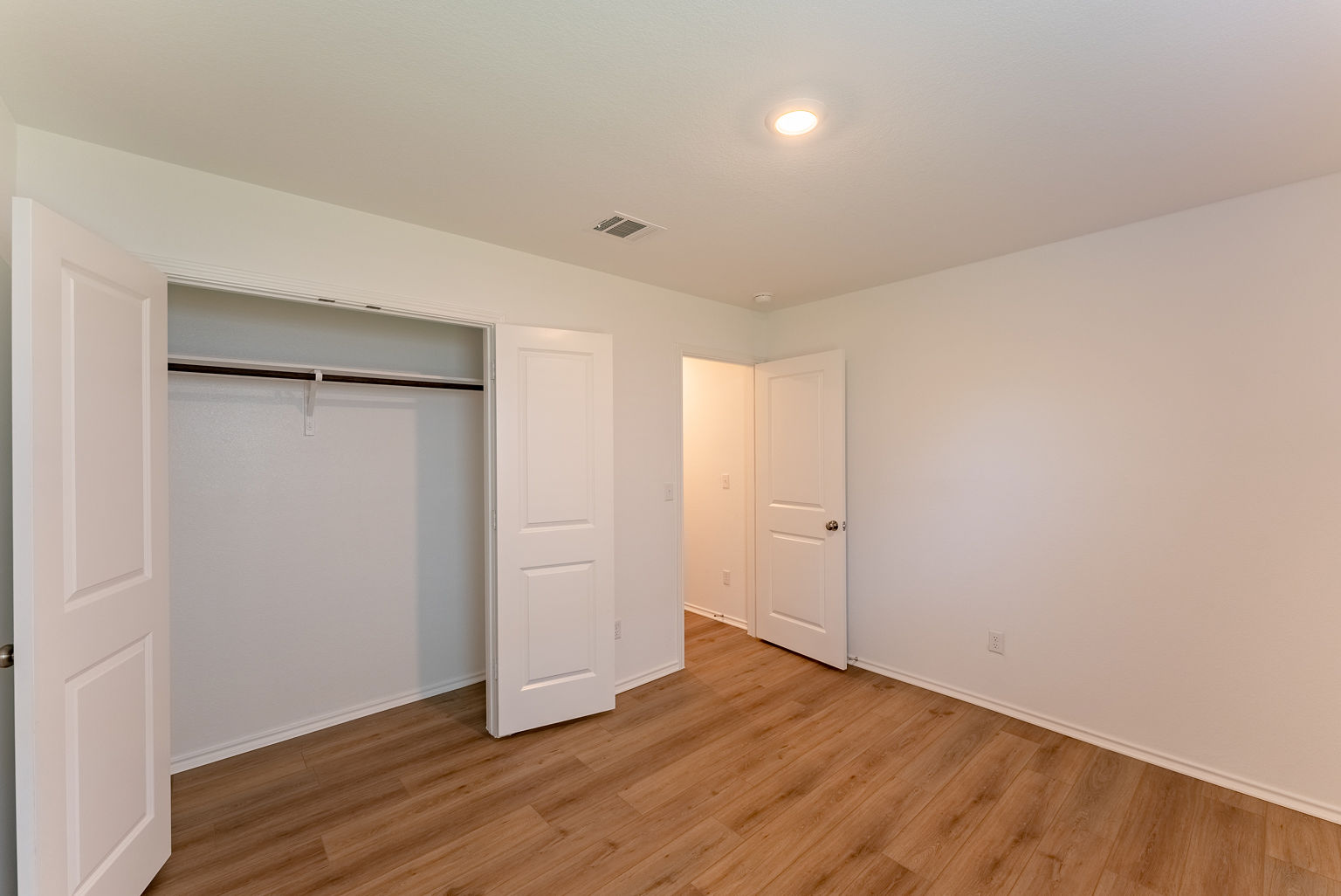 137 River Rise Road Kyle, TX 78640 - Photo 24 of 26 Unfurnished bedroom with light wood-type flooring, a closet, and recessed lighting