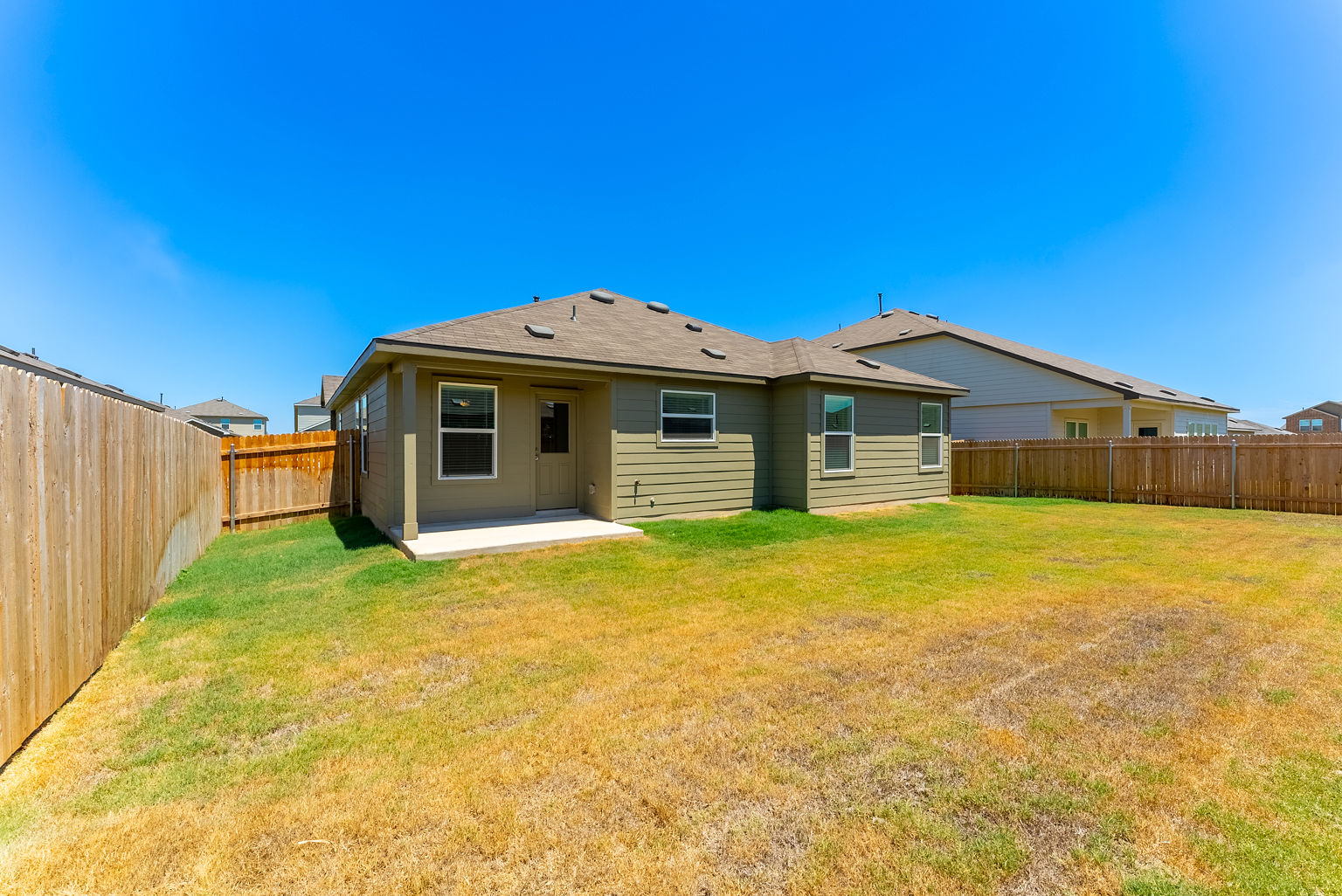 137 River Rise Road Kyle, TX 78640 - Photo 25 of 26 Rear view of property featuring a patio area, a fenced backyard, and roof with shingles