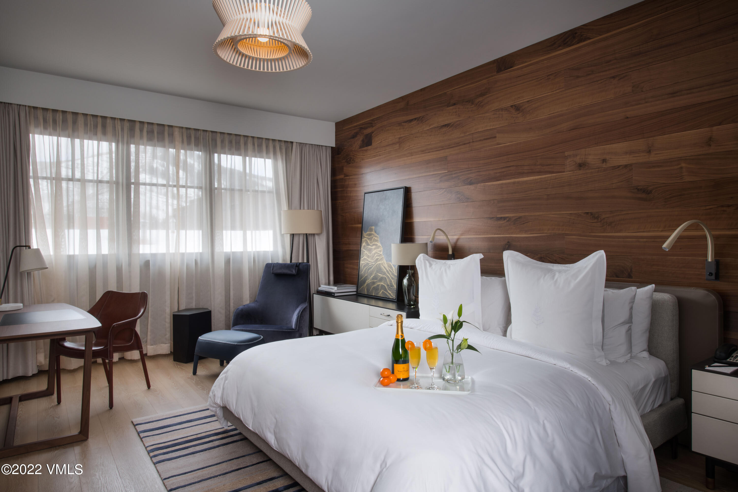 1 Vail Road, Unit 6103 Vail, CO 81657 - Photo 12 of 26 a bed sitting in a bedroom next to a window