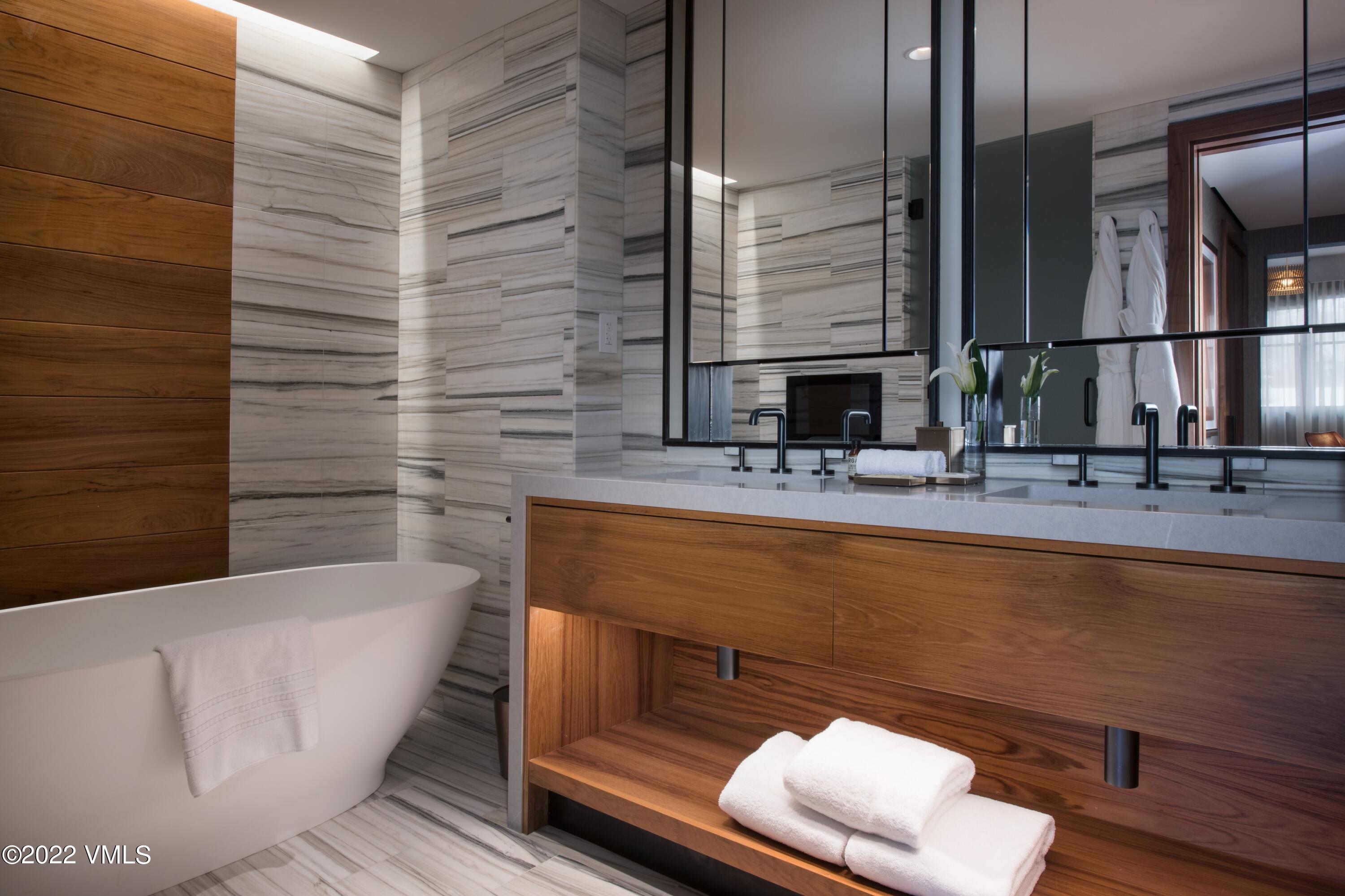 1 Vail Road, Unit 6103 Vail, CO 81657 - Photo 13 of 26 a bathroom with a bathtub and a sink