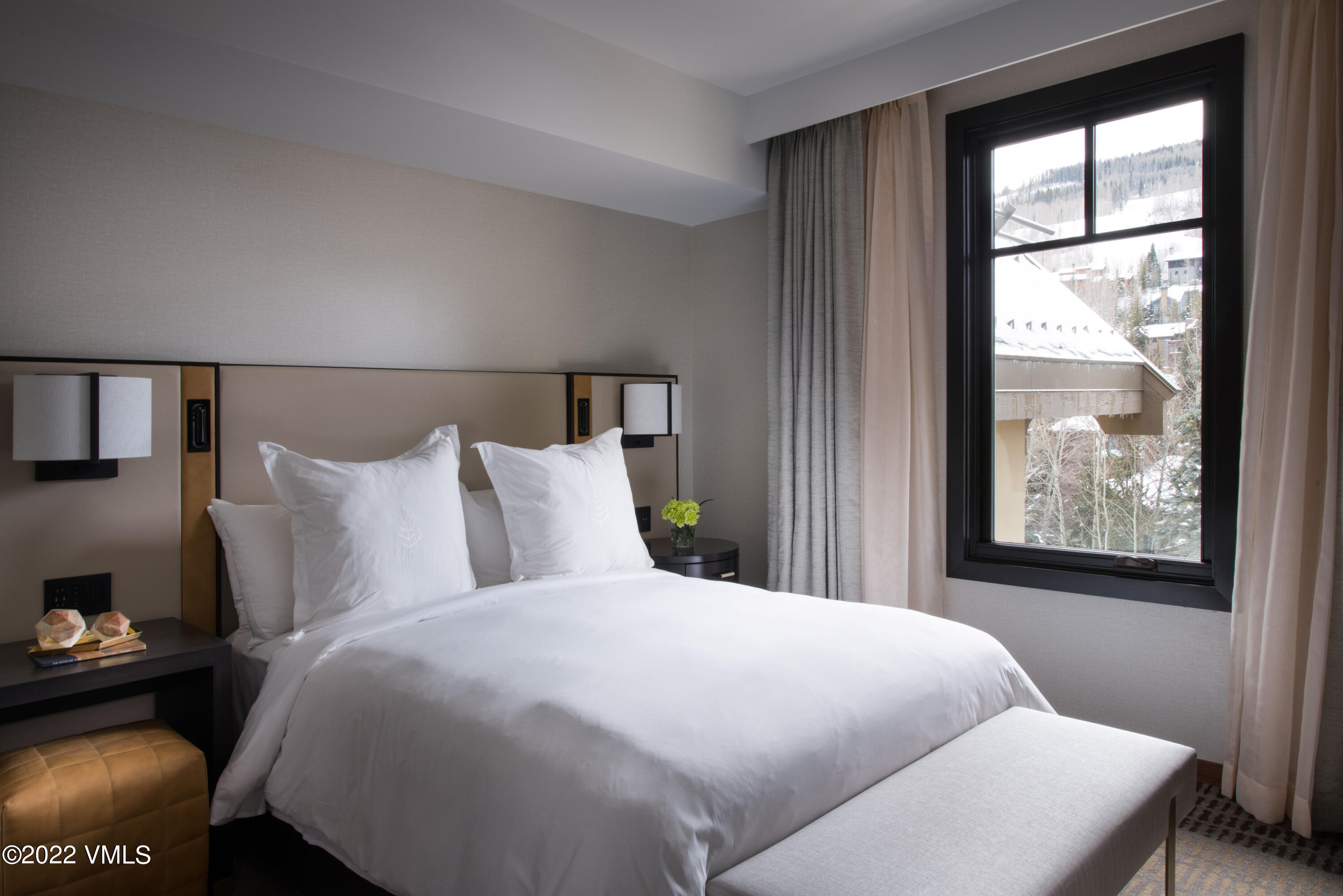 1 Vail Road, Unit 6103 Vail, CO 81657 - Photo 17 of 26 a bed sitting in a bedroom next to a window