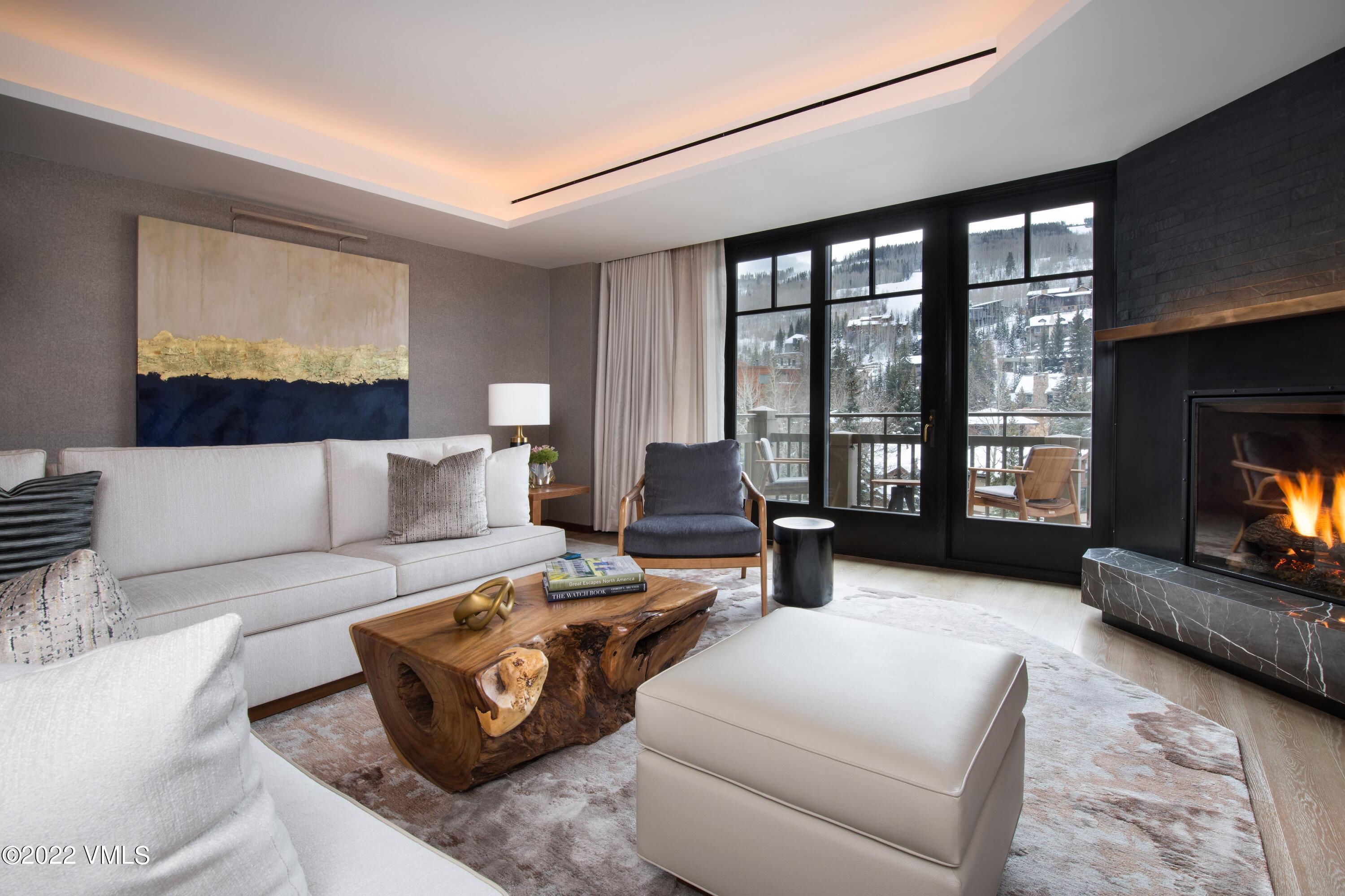 1 Vail Road, Unit 6103 Vail, CO 81657 - Photo 2 of 26 a living room with furniture large window and flat screen tv