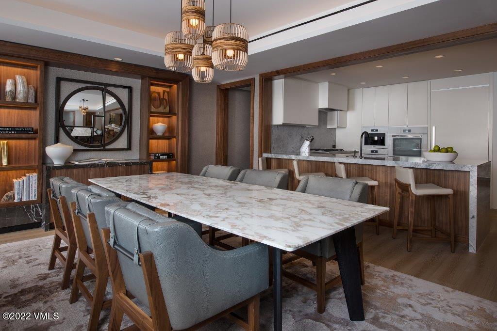 1 Vail Road, Unit 6103 Vail, CO 81657 - Photo 26 of 26 a dining table with chairs and wooden floor