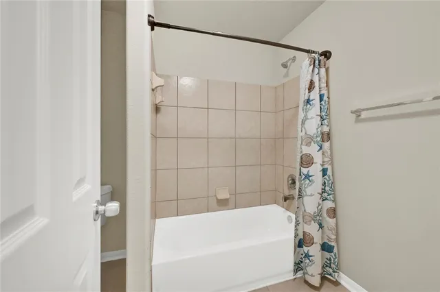 a bathroom with a bathtub and shower