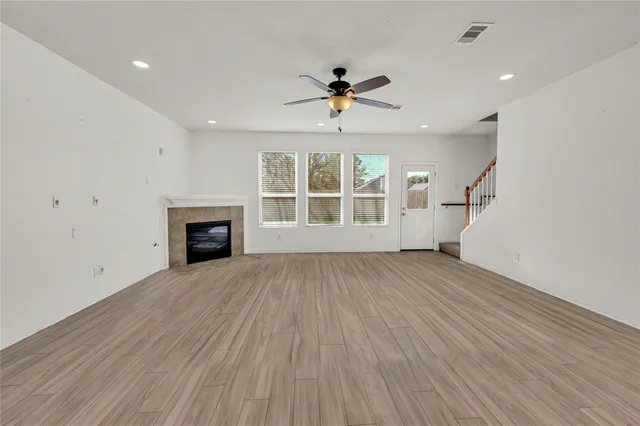 wooden floor in an empty room with a window